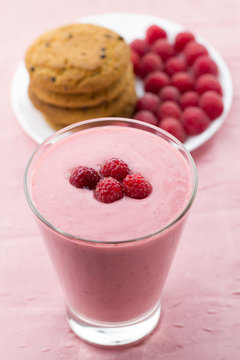 Raspberry smoothie with berries on wooden background. Healthy vegetarian food, diet.