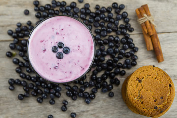 Blueberry smoothie with berries on wooden background. Healthy vegetarian food, diet.