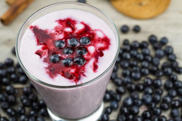 Blueberry smoothie with berries on wooden background. Healthy vegetarian food, diet.