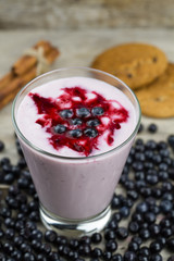 Blueberry smoothie with berries on wooden background. Healthy vegetarian food, diet.