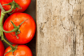 fresh ripe red tomatoes on wooden background