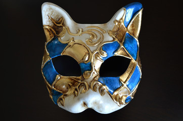 Venetian mask in the form of cat muzzle on dark background  

