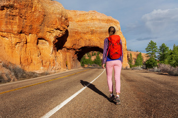 Woman walks on the road with Red canyon view