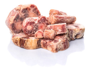 Raw frozen ox tail on white background