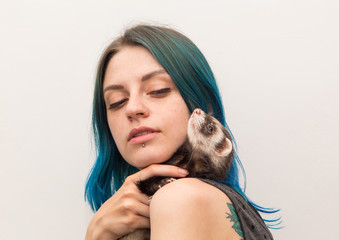 blue haired pretty girl plays with ferret