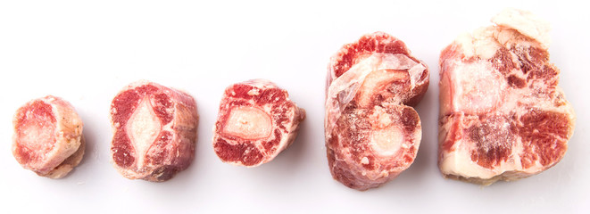 Raw frozen ox tail on white background