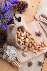 Roasted cashews nuts with natural on wood background
