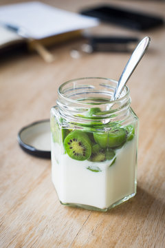 Plain Yogurt Served with Baby Kiwis in a Jar. Selective Focus on Fruits