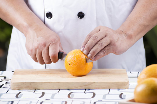 chef  cutting orange