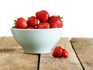 Sorted out. Misshaped strawberry and bowl of perfect fruit