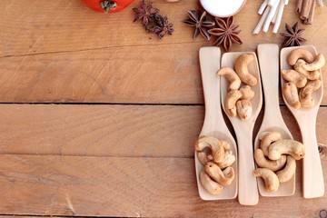 Roasted cashews nuts with natural on wood background