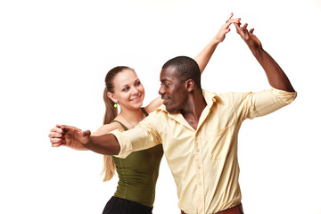 Young couple dances Caribbean Salsa, studio shot