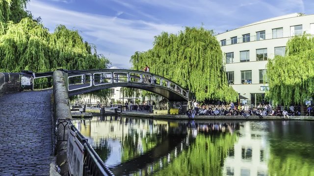 Time lapse view of people crossing a bridge over the canal at Camden town at the entrance of the famous Lock market in London