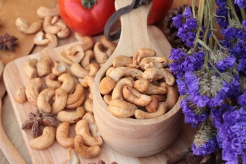 Roasted cashews nuts with natural on wood background