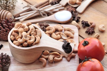 Roasted cashews nuts with natural on wood background