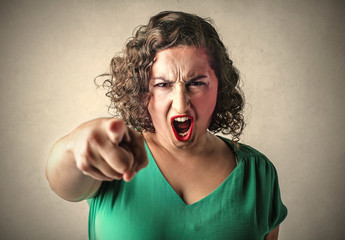 Angry woman judging someone - obrazy, fototapety, plakaty