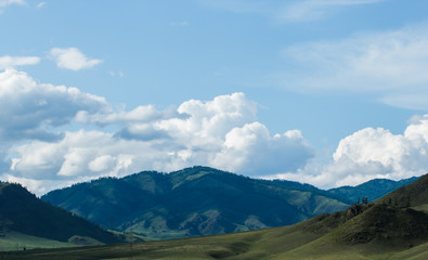 clouds over mountain peaks in Altai