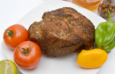 Baked meat with vegetables on the platter.