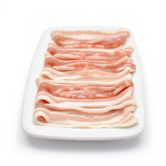 Bacon bits laid out on a plate. Isolated background