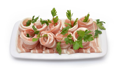 Rolled bacon with parsley isolated on white. Top view