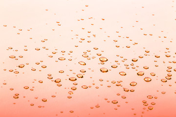 Drops on the orange mirror surface. selective focus
