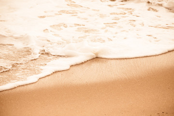 Sea beach in with white foam wave