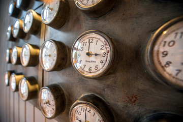 Metal wall with old styled clocks