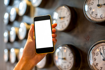 Holding phone with clocks on background