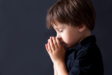 Little boy praying, child praying, isolated background - obrazy, fototapety, plakaty