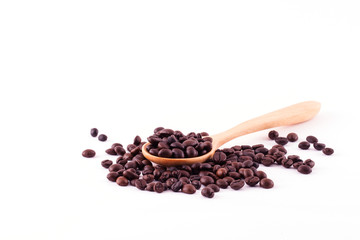 Spread coffee seeds on wooden spoon isolated on white background