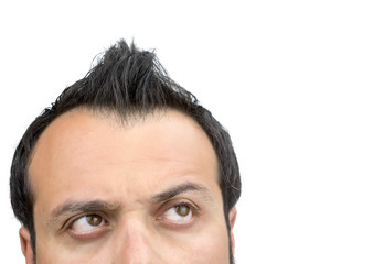 Closeup on upper part of males face looking up isolated on white