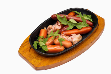 Sausages and bacon grilled on a clay plate