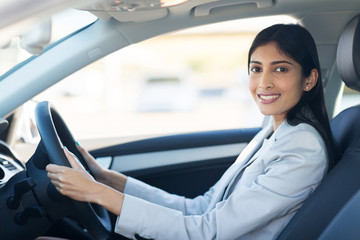 young indian businesswoman driving a car