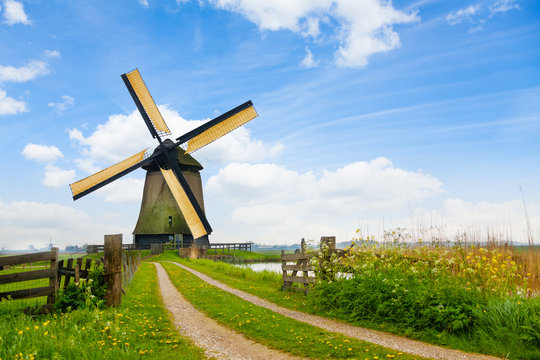 Rural road and windmill in Netherlands 