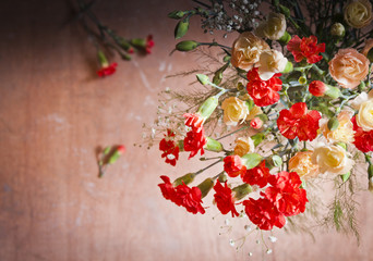 Carnations and gypsophelia against wooden background