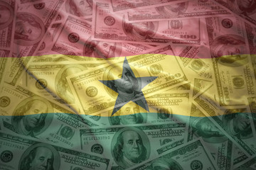 colorful waving ghanaian flag on a american dollar money background