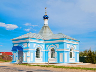 Fototapeta na wymiar Rural little blue church against the blue sky