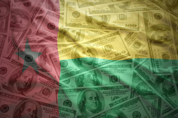 colorful waving guinea bissau flag on a american dollar money background