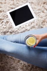 Closeup of a glass of water with lemon slices from above