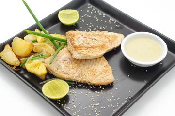 Grilled shark with baked potatoes isolated on white.