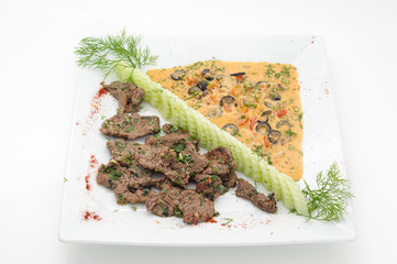 Ostrich stew with vegetable sause isolated on white.