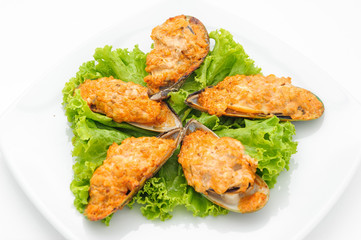 Grilled mussels with roasted cheese isolated on white.