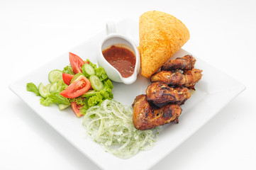 Deep fried chicken with crisp loaf and spicy sause isolated on white.