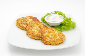 Potato cutlets with sour cream isolated on white.