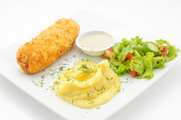 Chicken cutlet with mashed potatoes and green salad isolated on white.