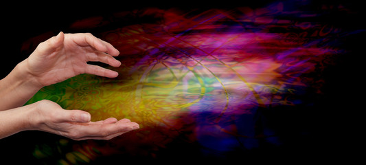 Fototapeta na wymiar Psychic healing energy field - Female outstretched healing hands on psychedelic multi colored flowing energy formation background