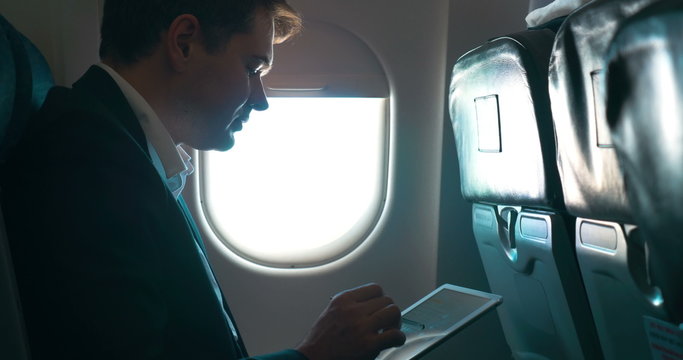 Man using tablet computer during the flight