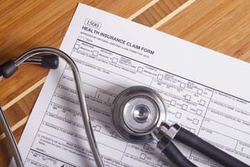 Medical insurance records, pen and Stethoscope