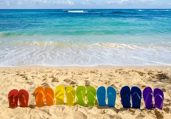 Zelfklevend Fotobehang Colorful flip flops on the sandy beach © ellensmile