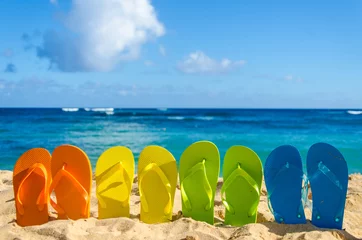 Zelfklevend Fotobehang Colorful flip flops on the sandy beach © ellensmile